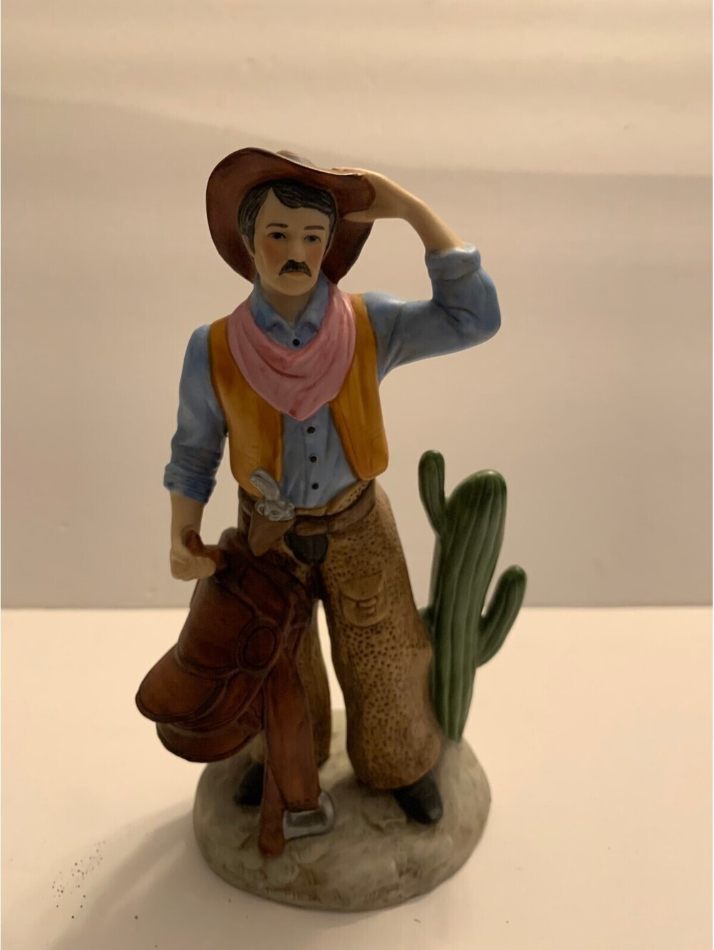 HOMCO Cowboy Porcelain Figurine #1419 Carrying Saddle Standing By Cactus 8" tall